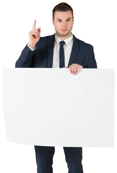 Empresário segurando cartão e apontando para cima — Fotografia de Stock