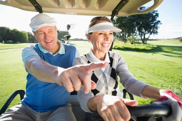 Golfing couple sitting in golf buggy — Stock Photo, Image