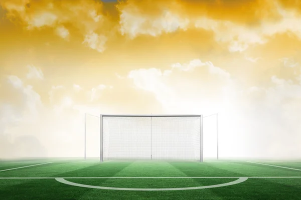 Футбольное поле под желтым небом — стоковое фото