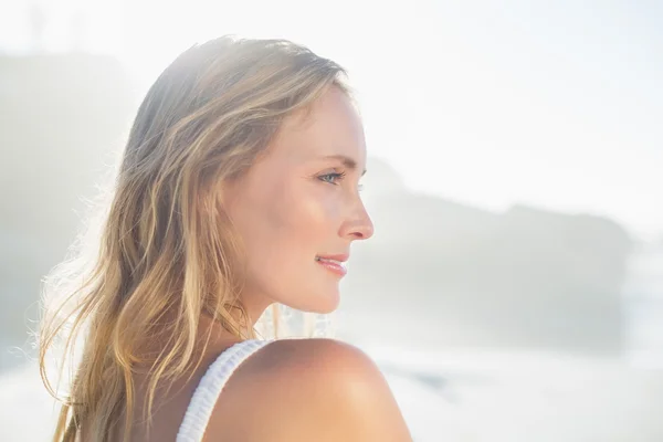 Blondine steht in Sonnenbrille am Strand — Stockfoto