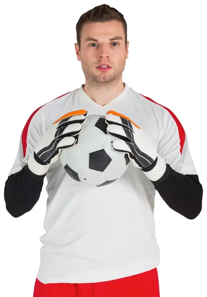 Goalkeeper in white holding ball — Stock Photo, Image