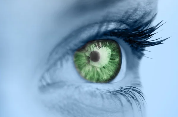 Green eye on blue face — Stock Photo, Image