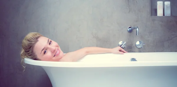 Serene blonde lying in bath — Stock Photo, Image
