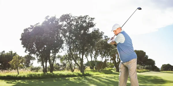 Golfer swinging on the grass — Stock Photo, Image