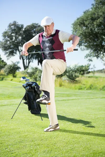 Angry golfer trying to break his club Stock Photo