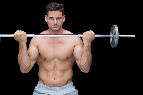 Serious crossfitter lifting up barbell — Stock Photo, Image