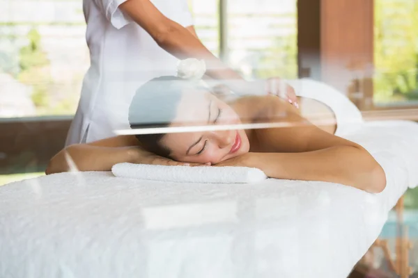 Brunette enjoying a peaceful massage — Stock Photo, Image