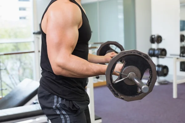 Muscular bodybuilder lifting barbell weight — Stock Photo, Image