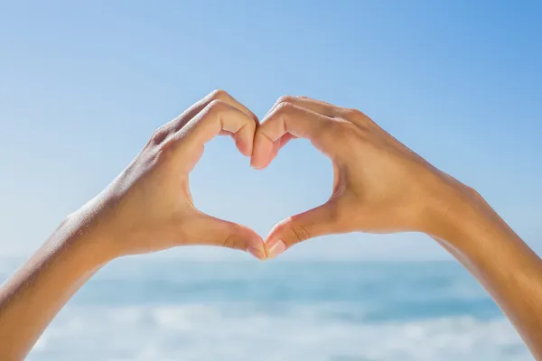 Female hands making heart shape — Stock Photo, Image