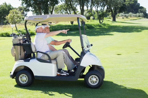 Golfing friends driving in golf buggy — Stock Photo, Image