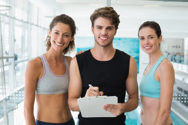 Fit women with trainer taking notes — Stock Photo, Image