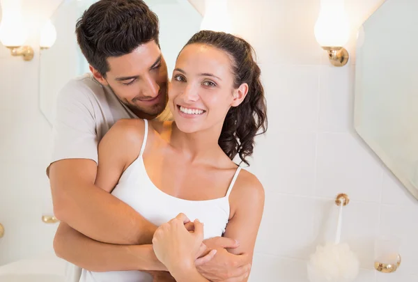 Attractive couple hugging in their pajamas — Stock Photo, Image