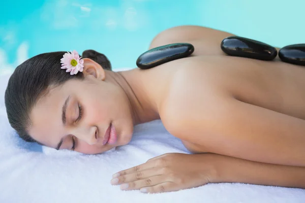 Brunette having a hot stone massage — Stock Photo, Image