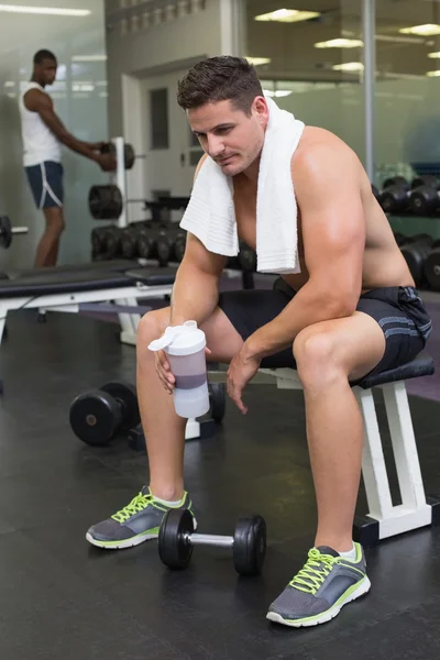 Bodybuilder holding protein drink — Stock Photo, Image