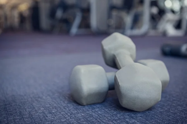 Dumbbells on the weights room floor — Stock Photo, Image