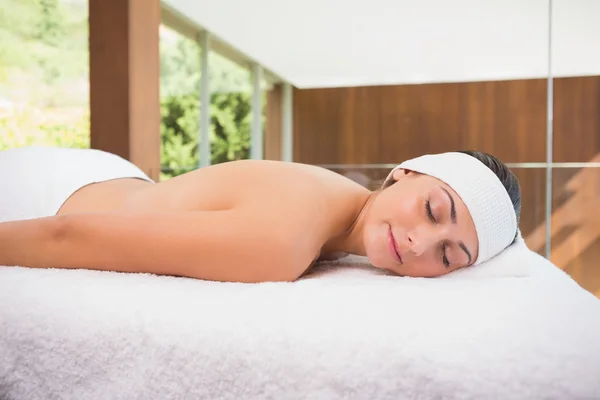 Brunette lying on massage table — Stock Photo, Image