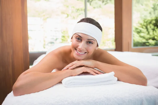 Brunette lying on massage table — Stock Photo, Image