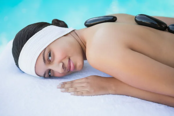 Brunette having a hot stone massage — Stock Photo, Image