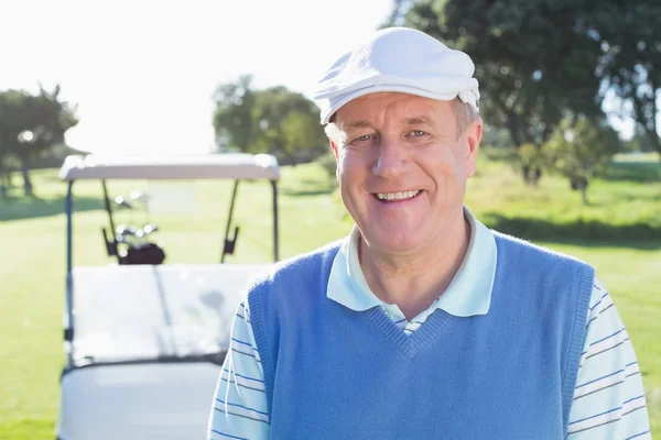 Golfer with golf buggy behind — Stock Photo, Image