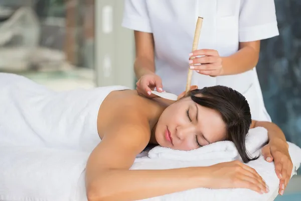 Brunette getting an ear candling treatment — Stock Photo, Image