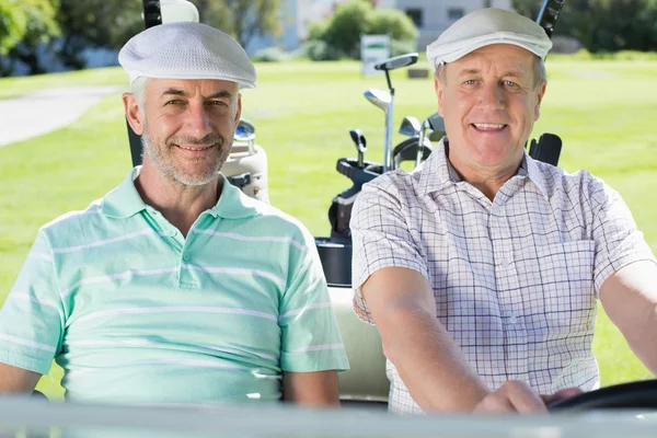 Golfing friends driving in golf buggy — Stock Photo, Image