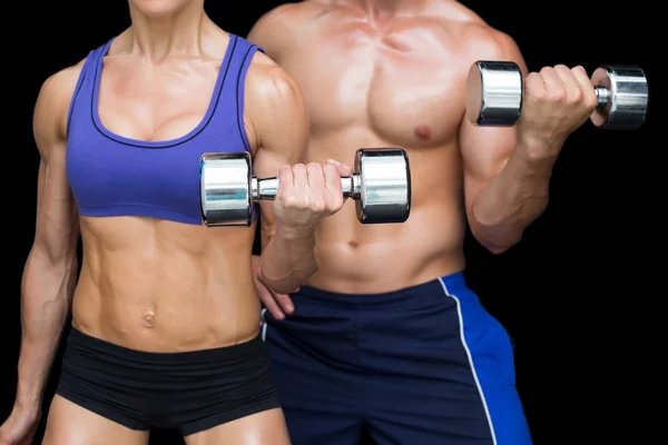 Musculação casal posando com grandes halteres — Fotografia de Stock