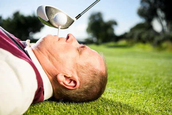 Tričko golfista hospodářství v zubech — Stock fotografie