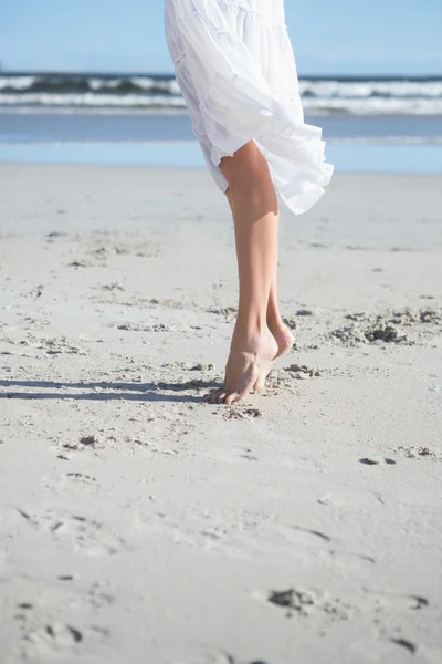 Mulher de vestido branco pisando na praia — Fotografia de Stock