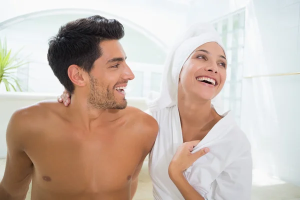 Attractive couple laughing in towels Stock Image
