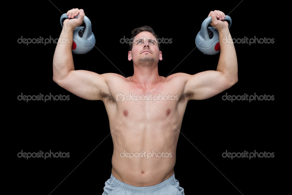 Strong bodybuilder lifting up kettlebells — Stock Photo