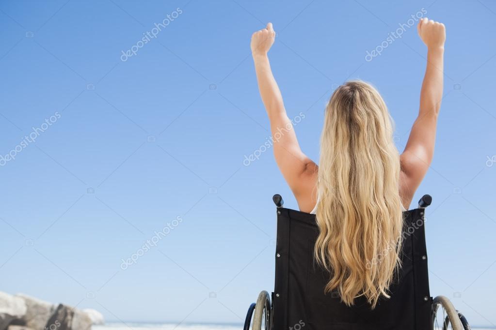 Wheelchair bound blonde with arms up — Stock Photo © Wavebreakmedia