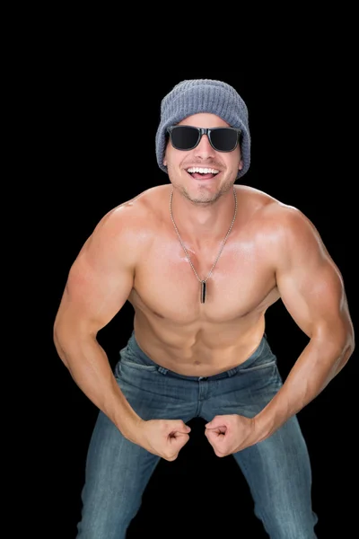 Muscular man in blue jeans and hat — Stock Photo, Image