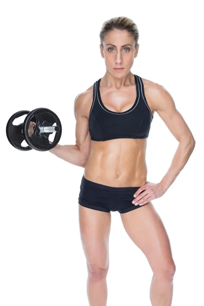 Female bodybuilder holding dumbbell — Stock Photo, Image