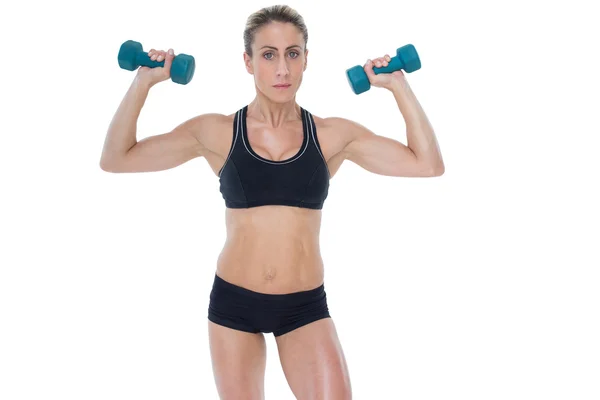 Female bodybuilder holding dumbbells — Stock Photo, Image