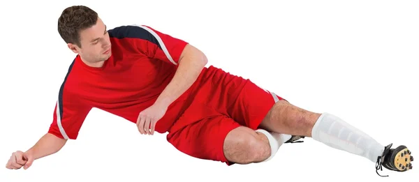 红色踢的足球运动员 — 图库照片