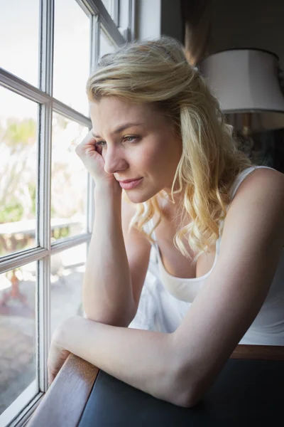 Blonde sitting by the window — Stock Photo, Image