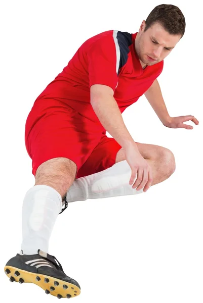 Football player in red kicking — Stock Photo, Image