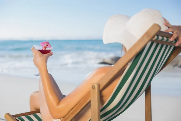 Woman relaxing in deck chair with cocktail — Stock Photo, Image