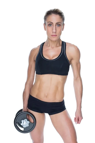 Female bodybuilder holding dumbbell — Stock Photo, Image