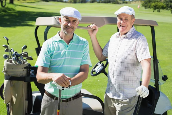 Golfing friends beside their buggy — Stock Photo, Image