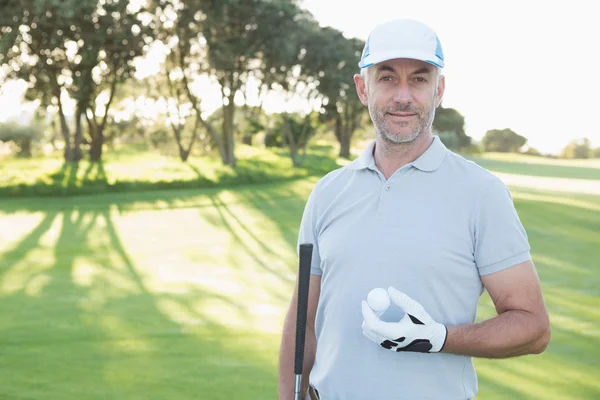 Handsome golfer with golf ball — Stock Photo, Image