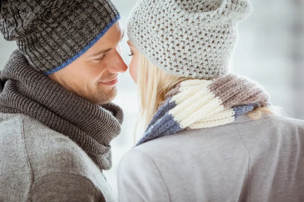 Couple in warm clothing facing each other — Stock Photo, Image