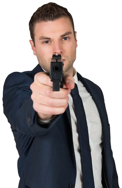 Serious businessman pointing gun — Stock Photo, Image