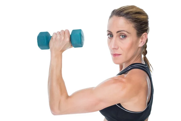 Female bodybuilder holding dumbbell — Stock Photo, Image