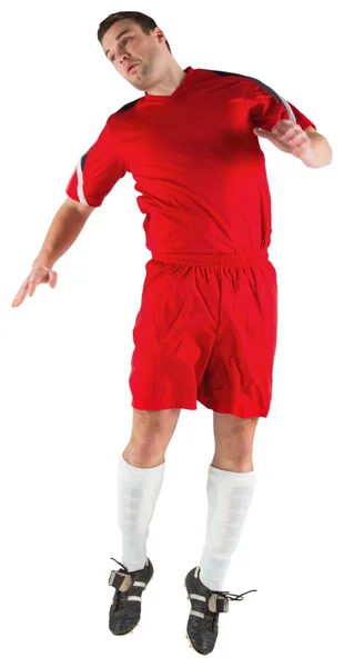 Football player in red jumping — Stock Photo, Image