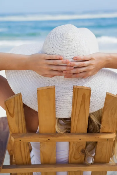 Woman sitting in deck chair — Stock Photo, Image