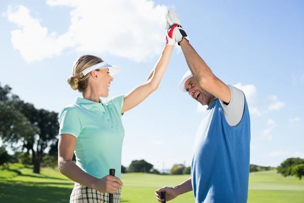 Golfing couple high fiving — Stock Photo, Image