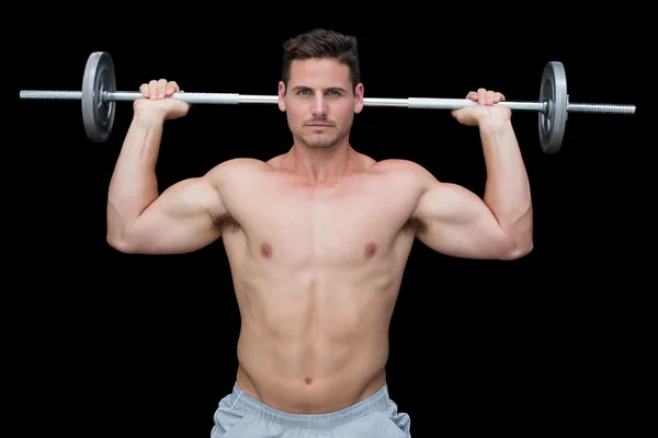 Serious crossfitter lifting up barbell — Stock Photo, Image