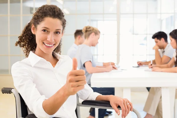 Businesswoman in wheelchair smiling — Stock Photo, Image