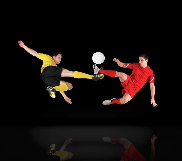 Football players tackling for the ball — Stock Photo, Image